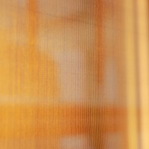 Détail de tissu lumineux rétroéclairé doré, matériau utilisé pour luminaires design personnalisés et créations d’éclairage sur mesure